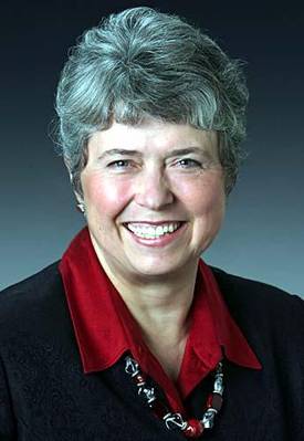 Headshot of Rep Sharon Cissna, wearing red shirt and suit jacket