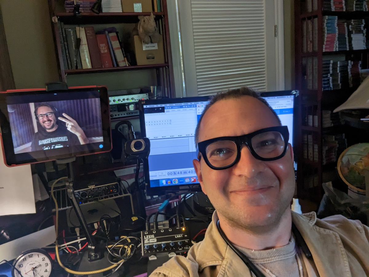 A selfie taken at Skyboat Media, at director Gabrielle de Cuir's workstation, showing Cory Doctorow and Wil Wheaton; Wheaton is telepresent via a tablet.