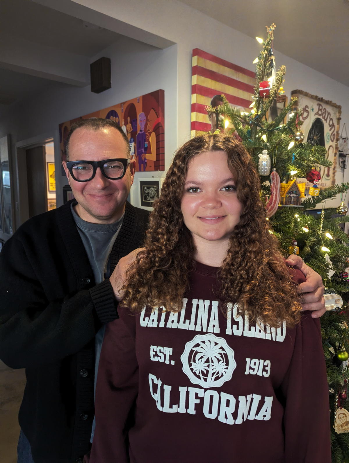 My daughter Poesy and me, standing with our Christmas Tree in our living room.